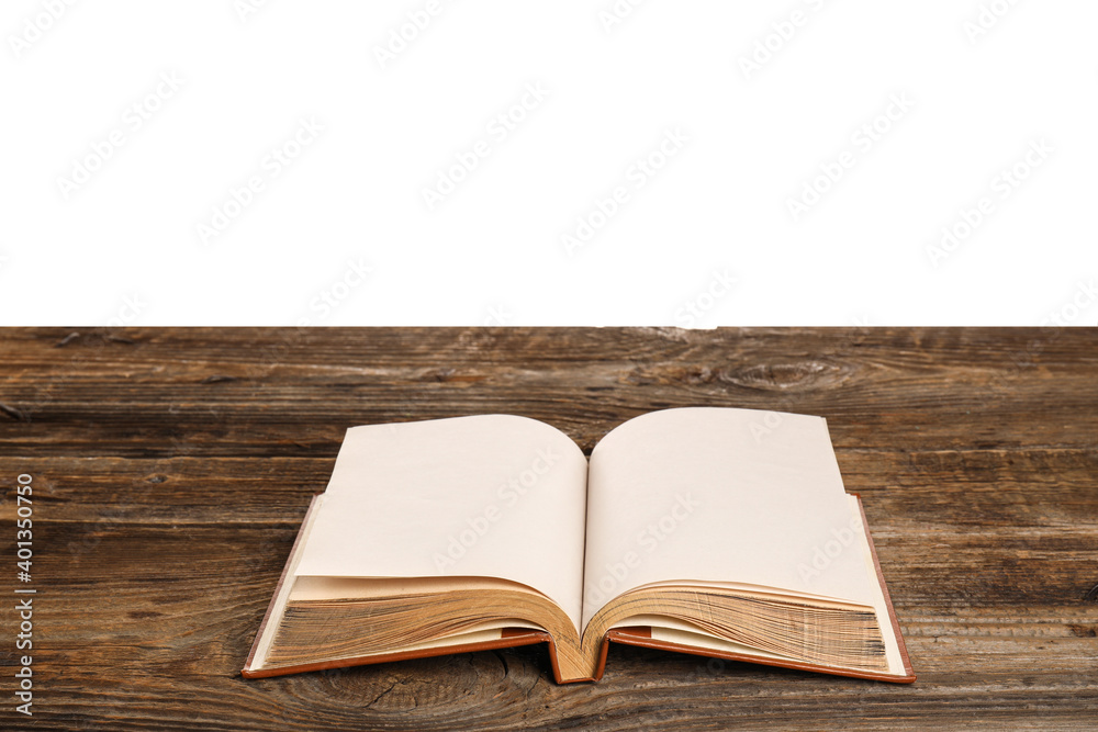 Open old book on table against white background