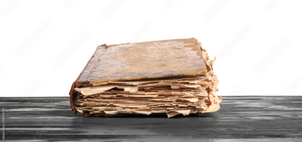 Old book on table against white background