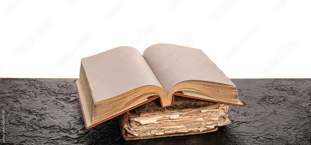 Old books on table against white background