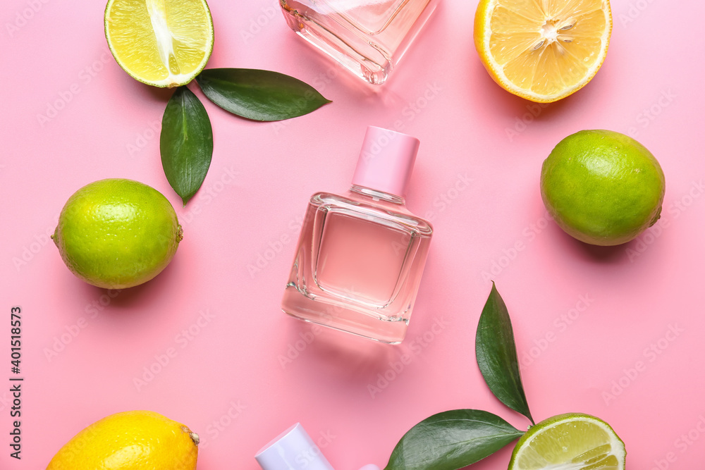 Bottles of citrus perfume on color background