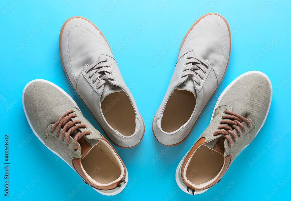 Casual male shoes on color background