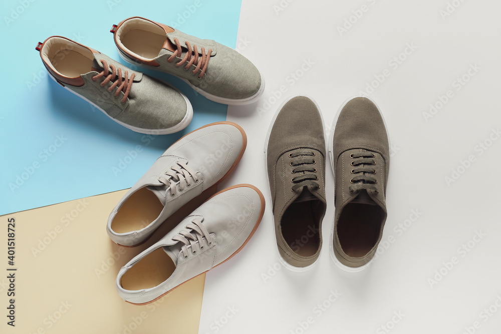 Casual male shoes on color background