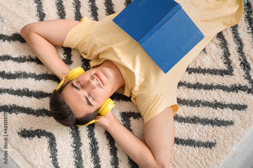 Young man listening to music at home