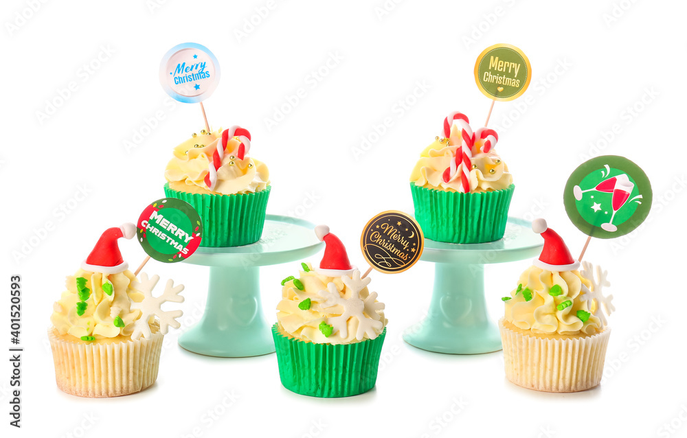 Tasty Christmas cupcakes on white background