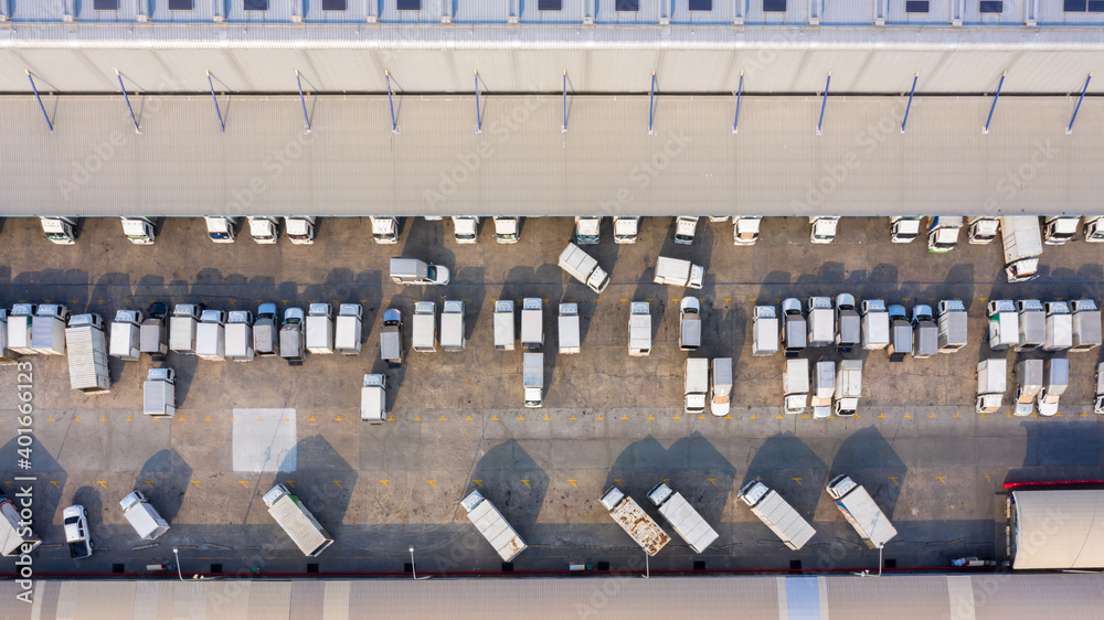 Aerial view logistics center in industrial city, Industrial warehouse loading dock where many truck 