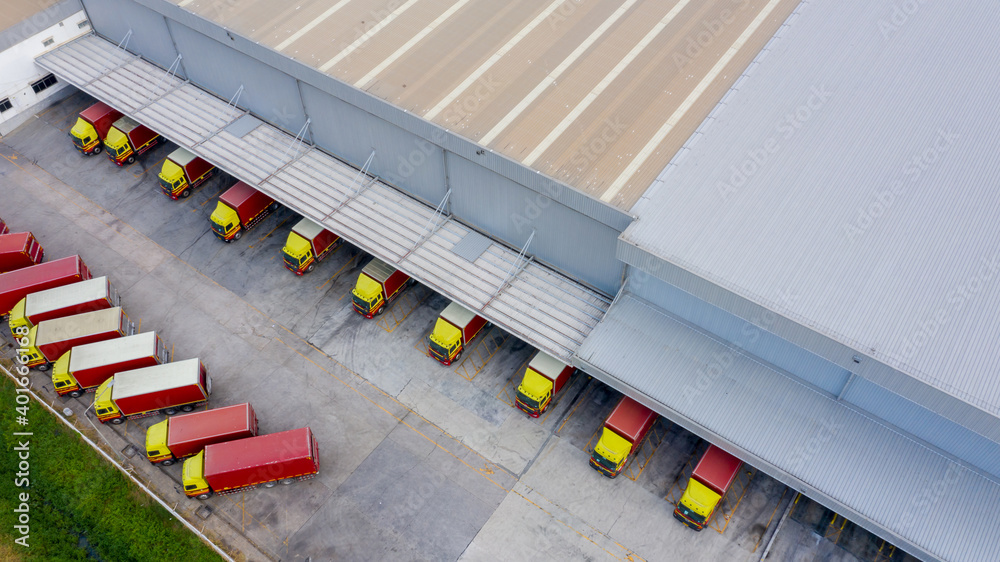 Aerial view logistics center in industrial city, Industrial warehouse loading dock where many truck 