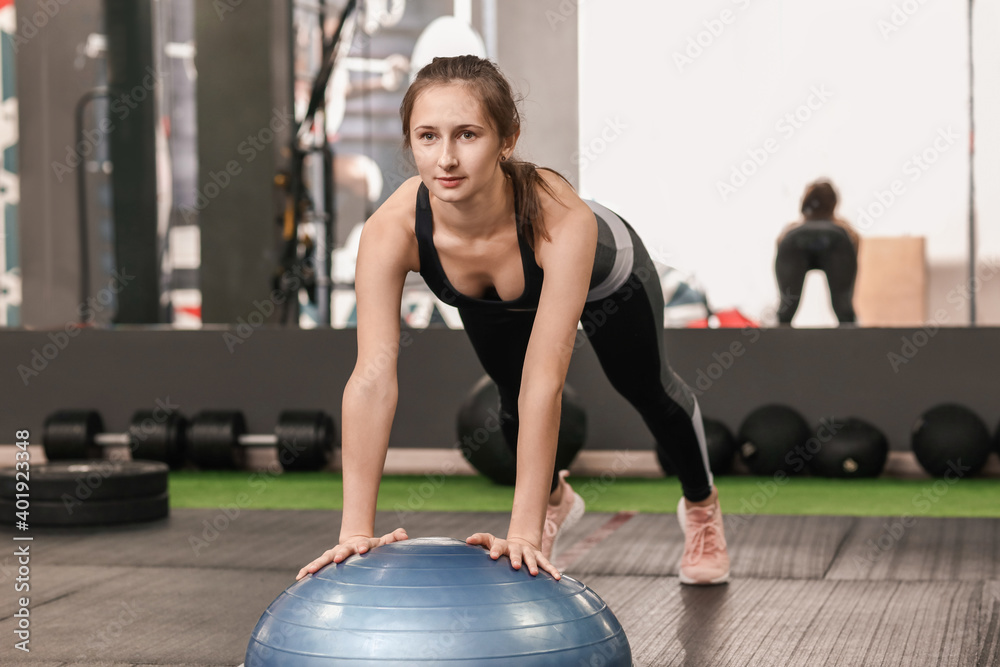 Sporty young woman training in gym