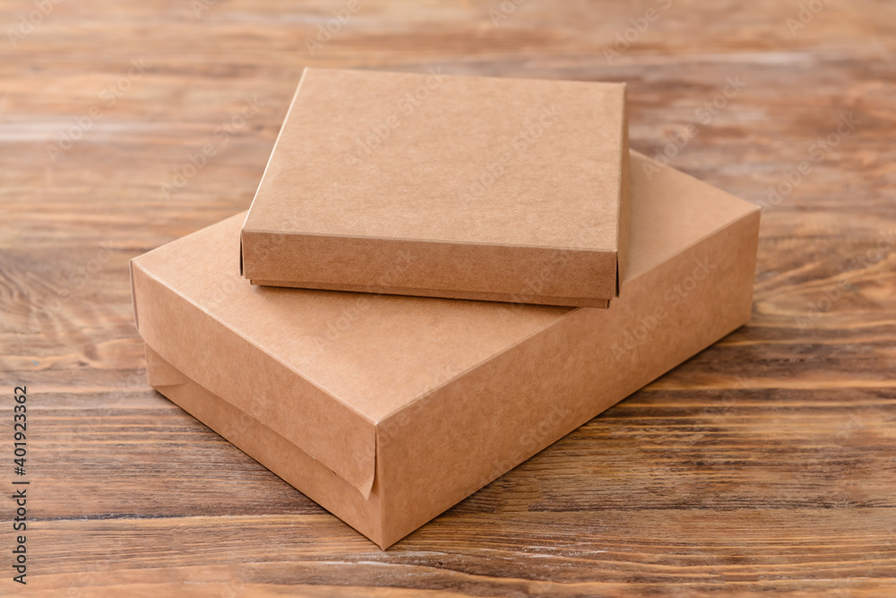 Blank cardboard boxes on wooden background