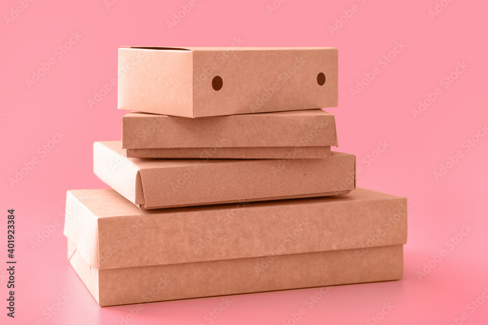 Blank cardboard boxes on color background