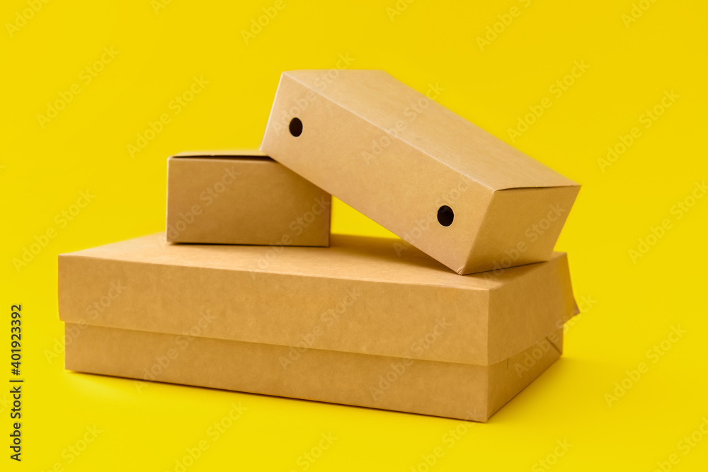 Blank cardboard boxes on color background