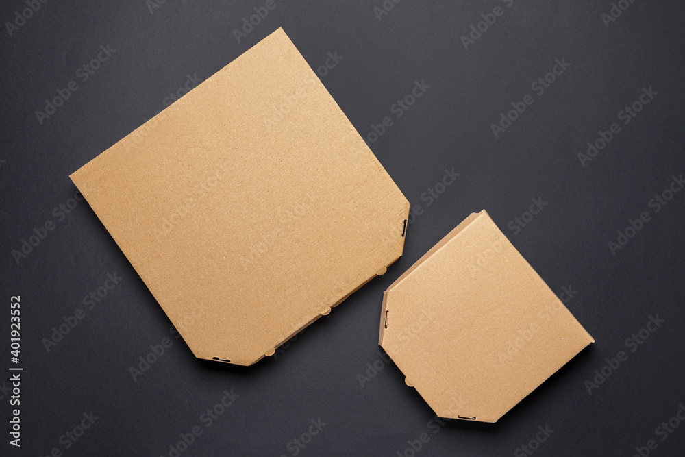 Cardboard pizza boxes on dark background