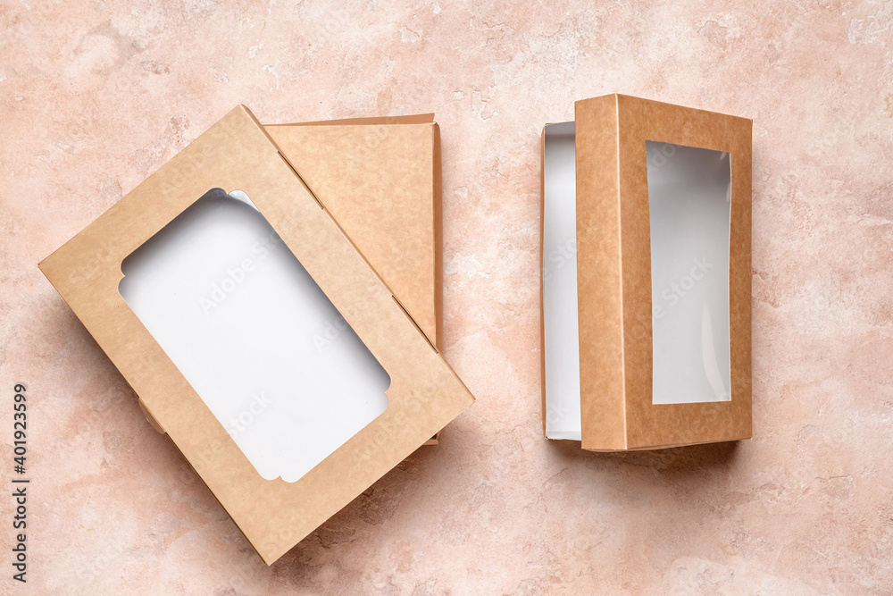 Blank cardboard boxes on color background