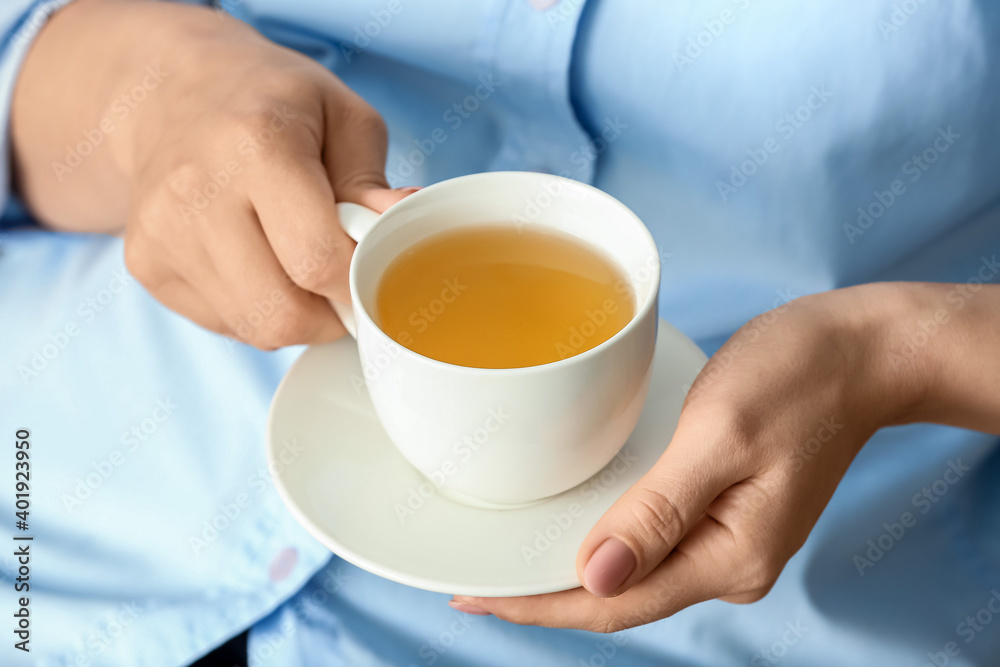 Woman with cup of green tea, closeup