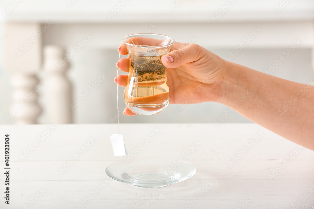 Female hand with glass of green tea, closeup