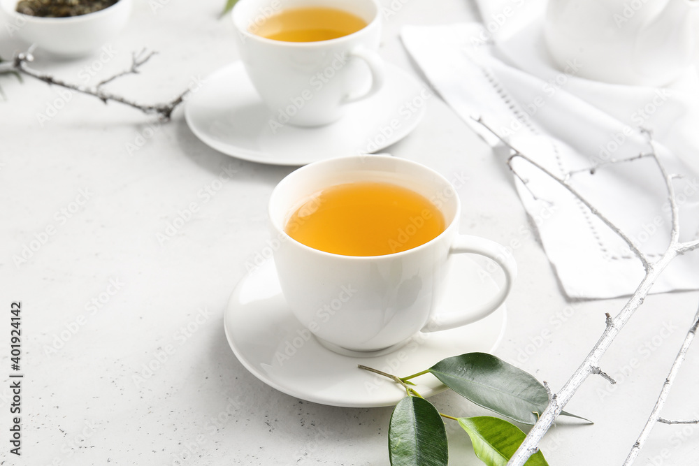 Cups of green tea on table