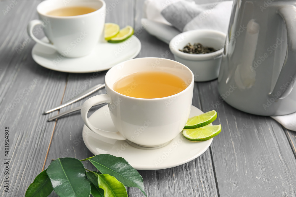 Composition with cups of green tea on wooden table