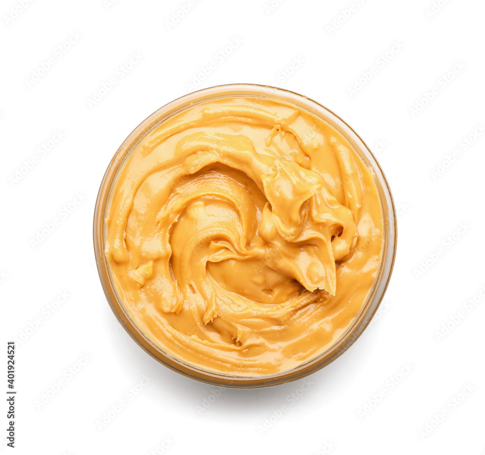 Bowl with tasty peanut butter on white background