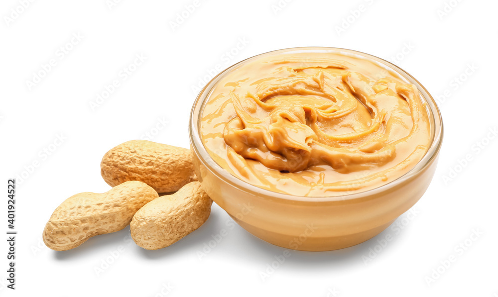 Bowl with tasty peanut butter and nuts on white background