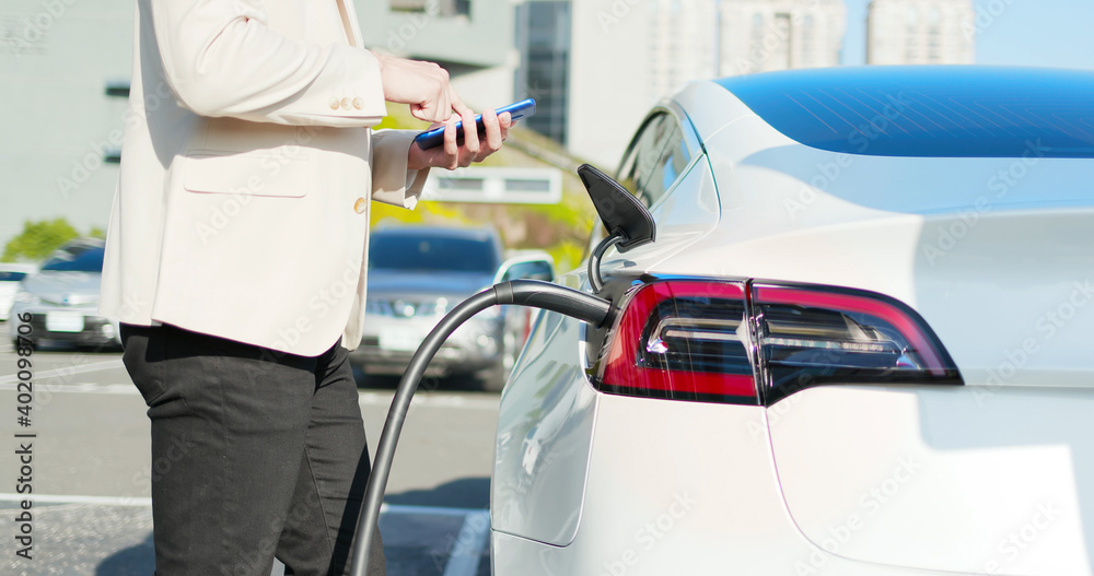 man Charges electric car