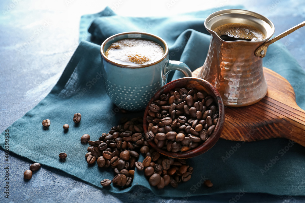 Composition with cup of coffee and cezve on table