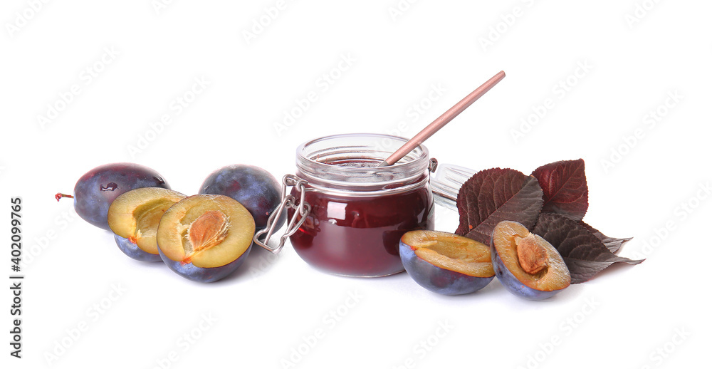 Glass jar with delicious homemade plum jam on white background