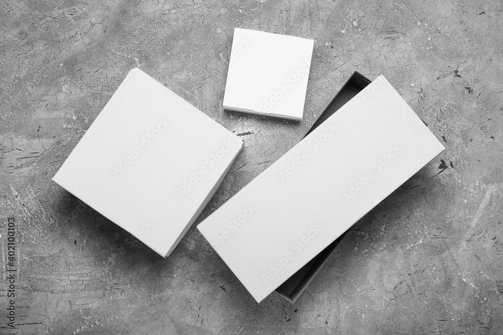 Blank cardboard boxes on gray background