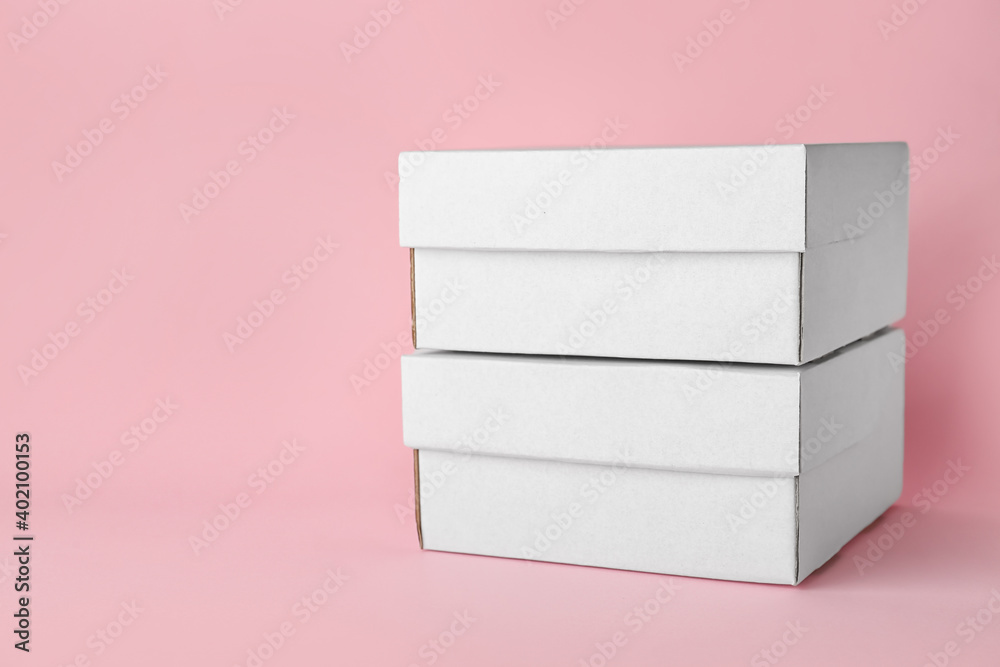 Blank cardboard boxes on color background