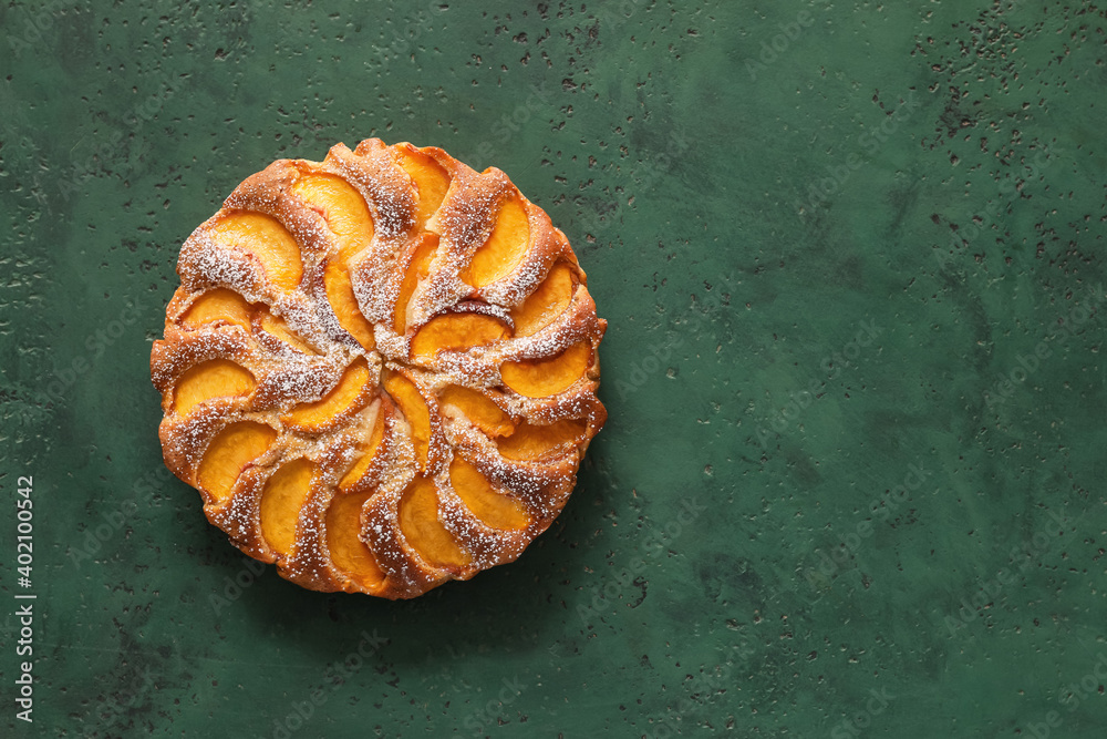 Tasty peach pie on color background