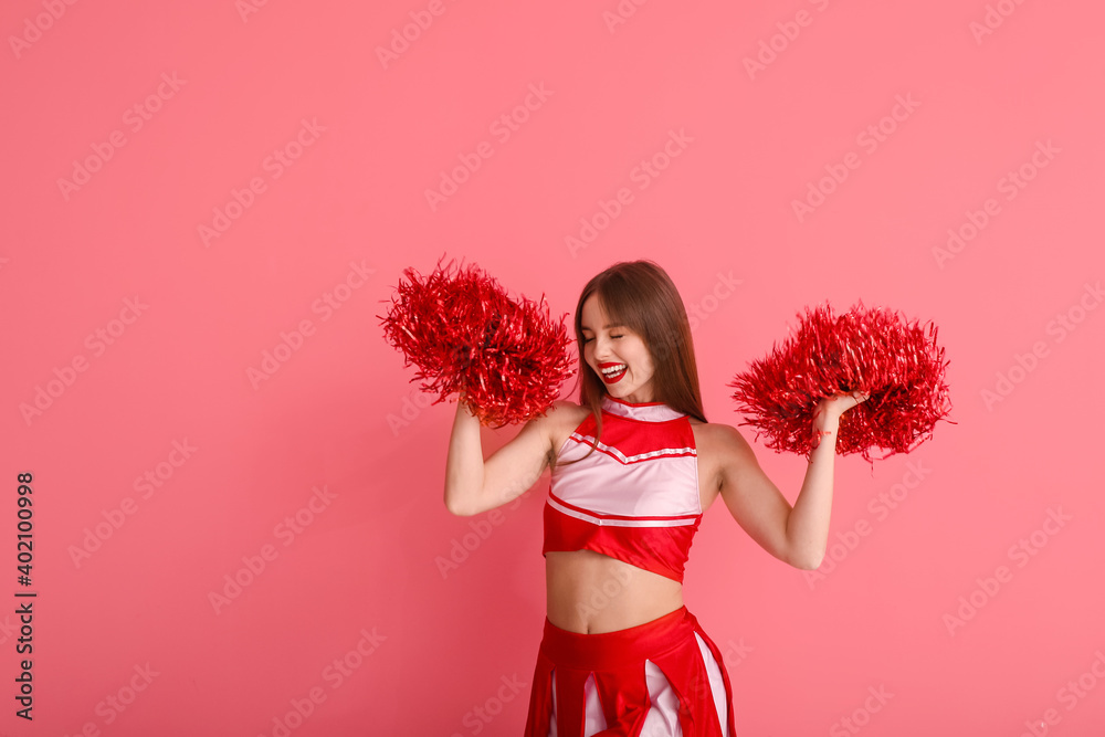 Beautiful young cheerleader on color background