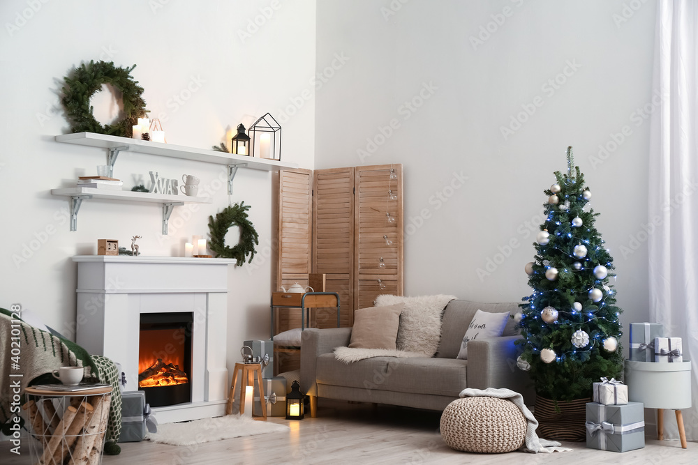 Interior of living room with beautiful Christmas tree and fireplace