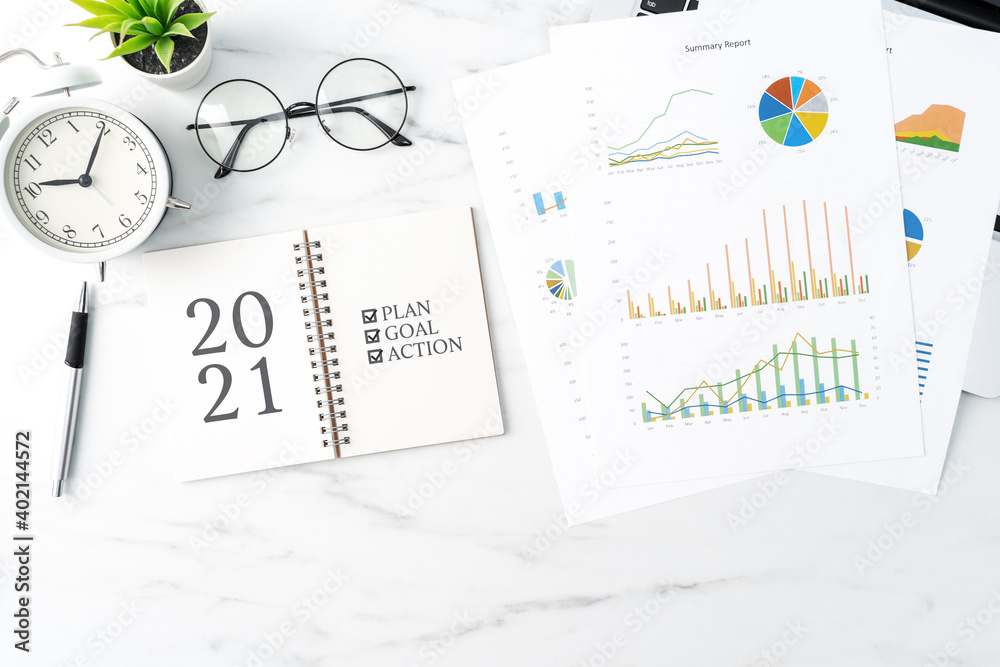 Top view of office table desk 2021 Goal work concept on bright marble white background.