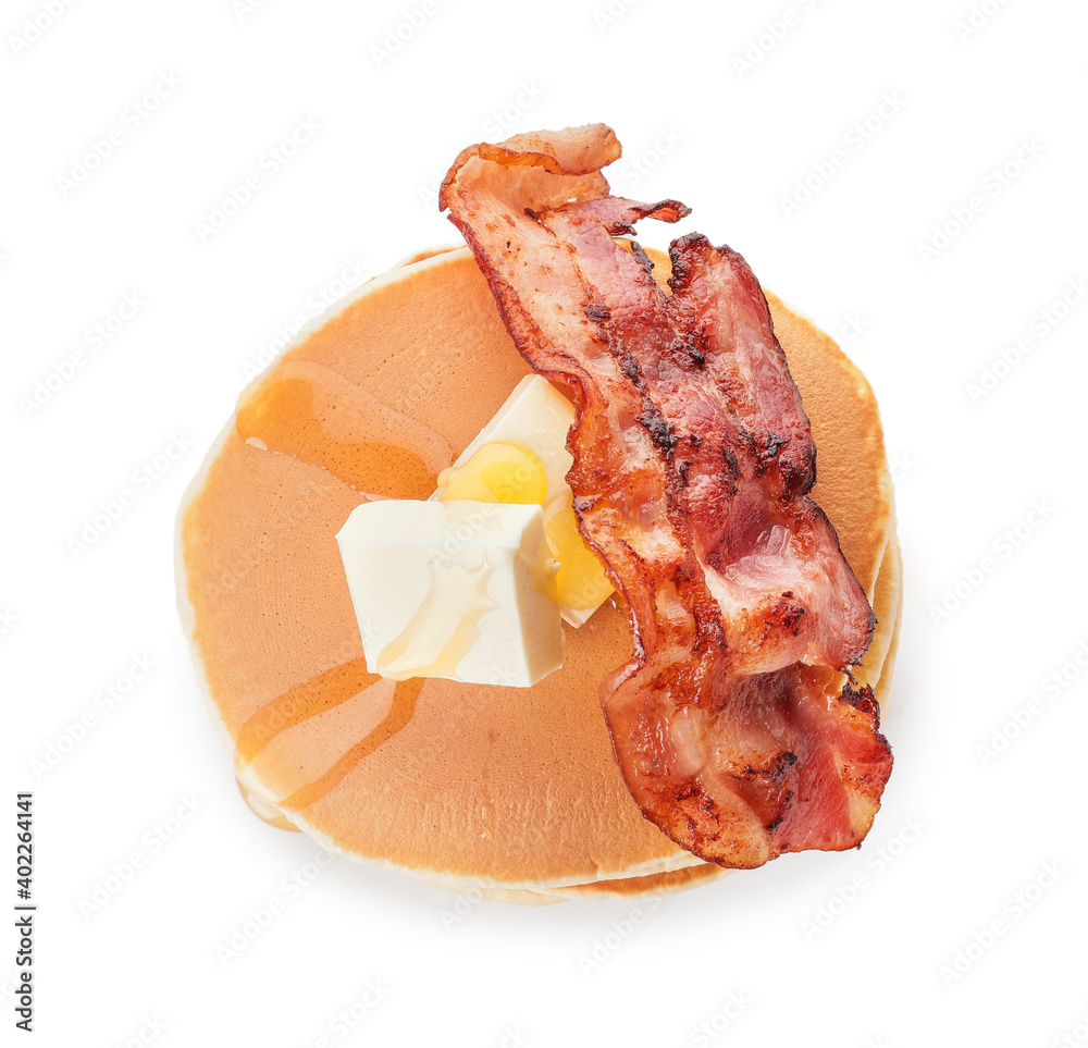 Tasty pancakes with fried bacon and butter on white background