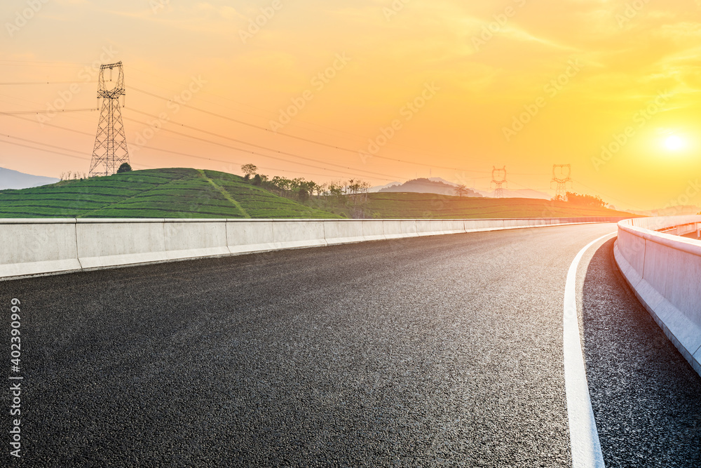 Asphalt road and mountain with tea plantation at sunset.Road and mountain background.