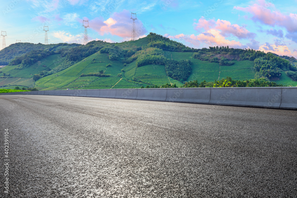 Asphalt road and mountain at sunset.Road and mountain background.