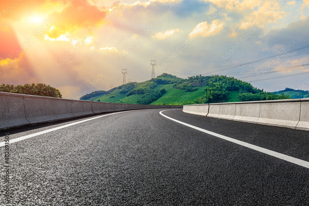 Asphalt road and mountain with tea plantation at sunset.Road and mountain background.