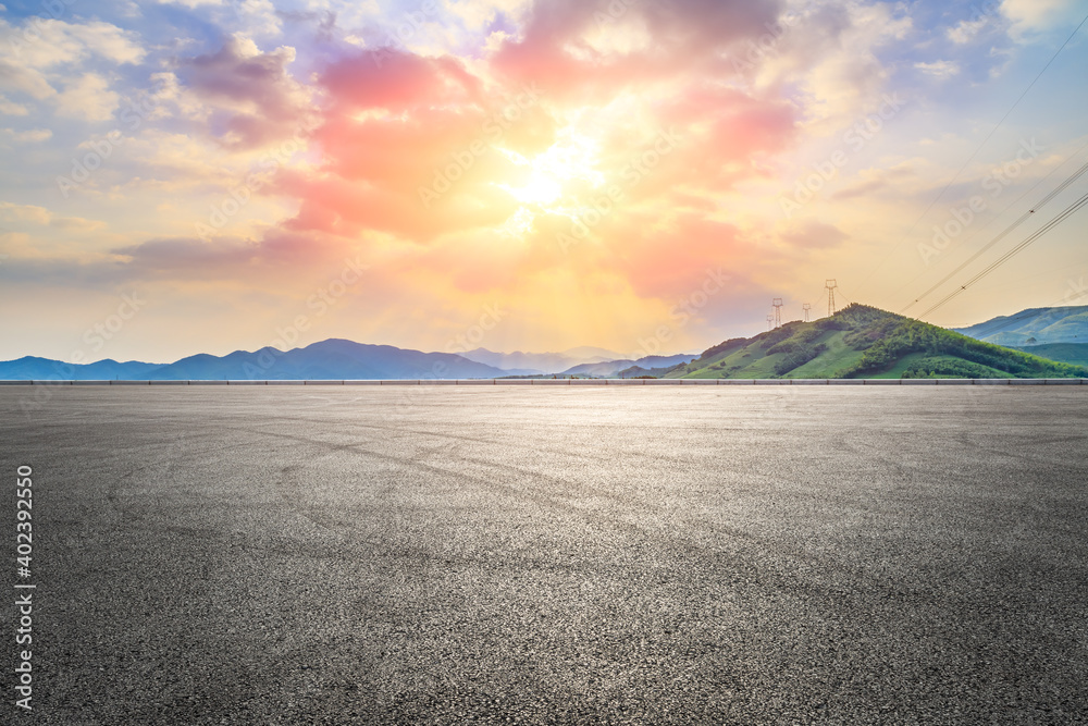 Asphalt road ground and mountain at sunset.Race track road and mountain background.