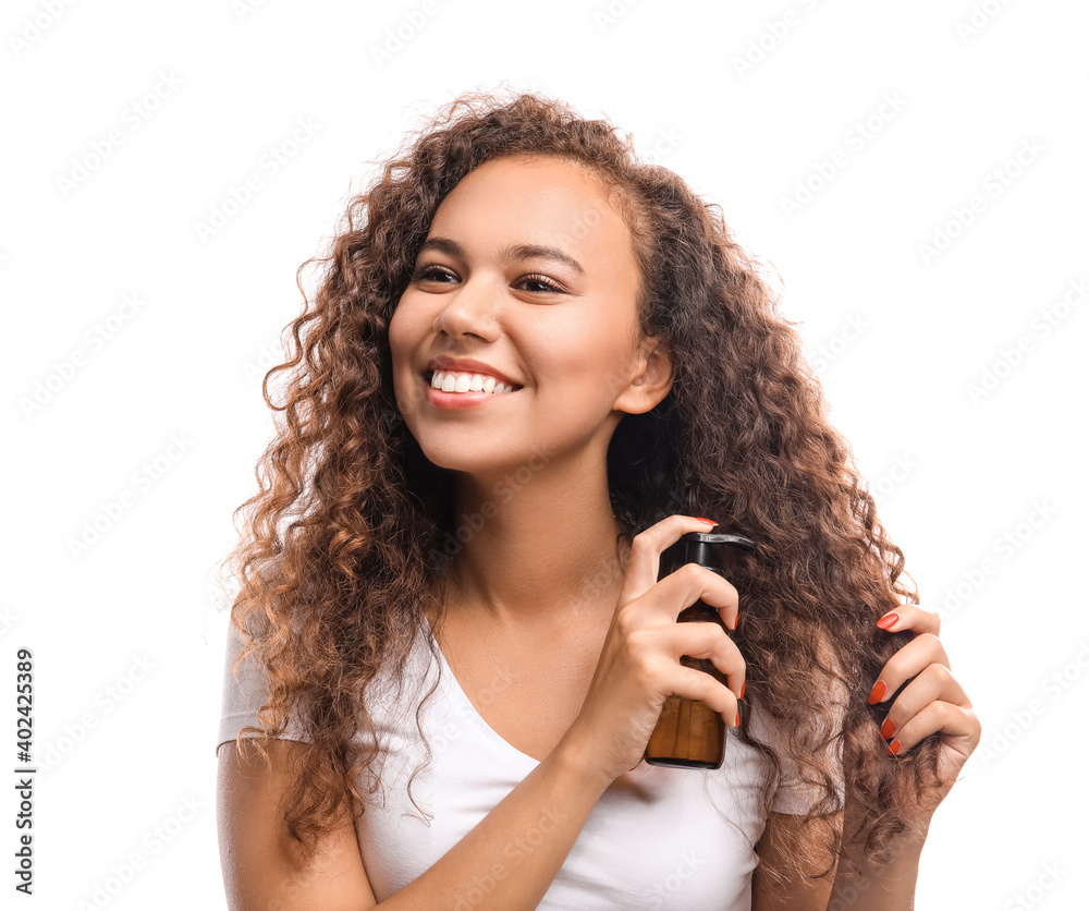 Beautiful young woman with cosmetic oil on white background