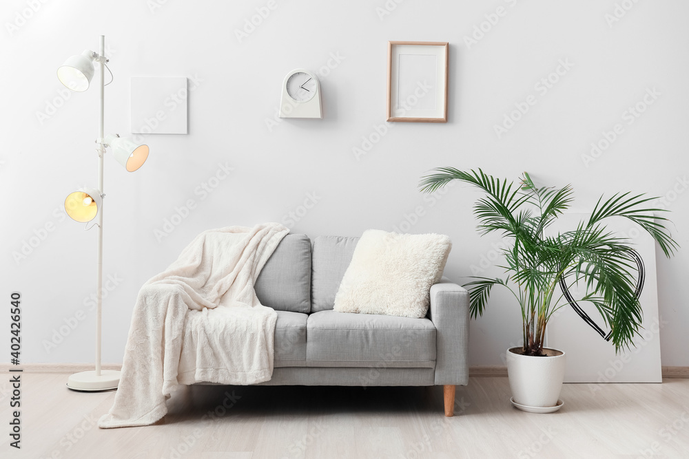 Stylish sofa in interior of living room