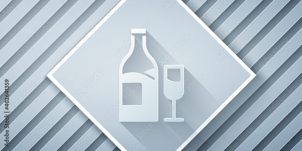 Paper cut Wine bottle with glass icon isolated on grey background. Paper art style. Vector.