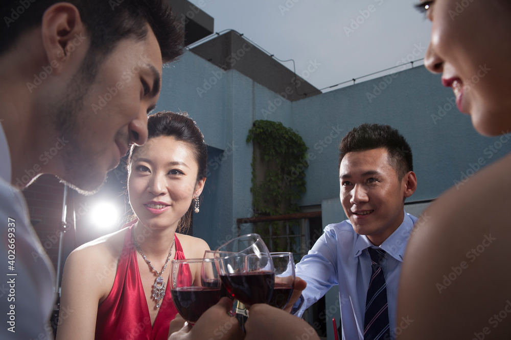 Four people sit together for dinner and chat