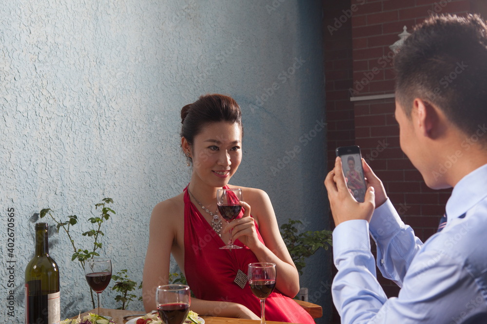 Young men take photos with mobile phones