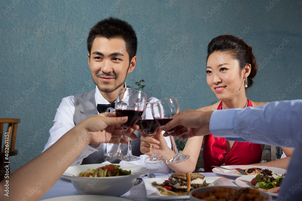 Four people sit together for dinner and chat