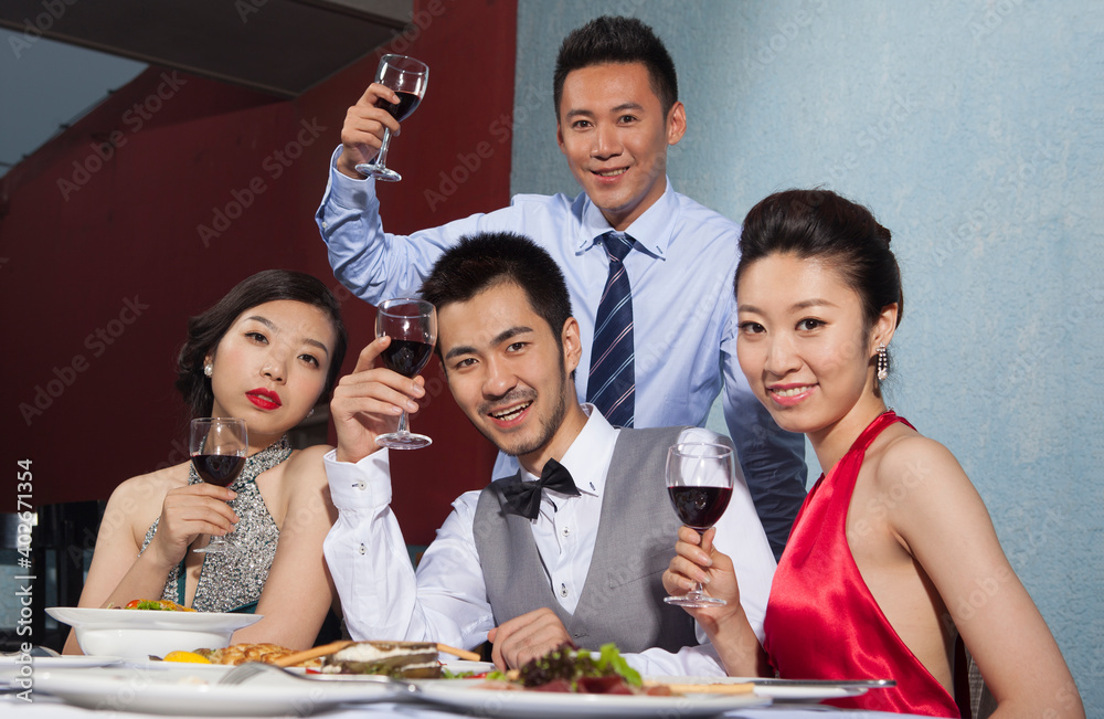 Four people sit together for dinner and chat