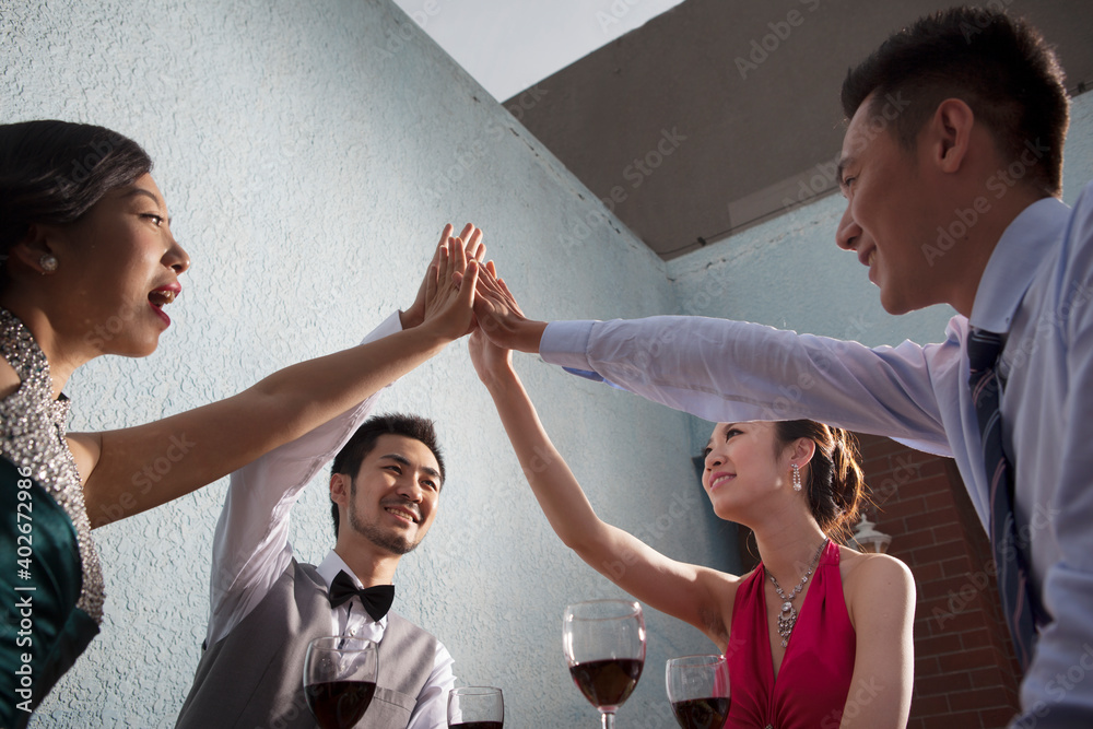 Four people sit together for dinner and chat