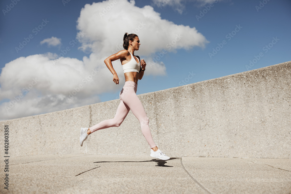 Sporty woman running outdoors