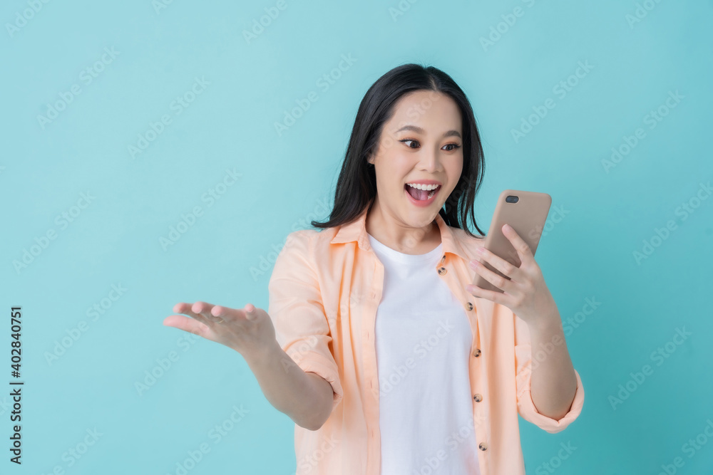 Beautiful Asian woman. She feels shocked with the phone