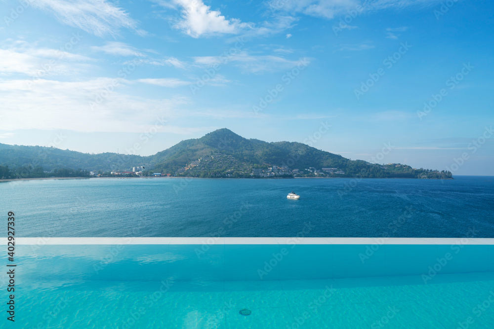 Swimming pool with stair on top of roof deck building looking at view tropical sea ,Luxury beach vil