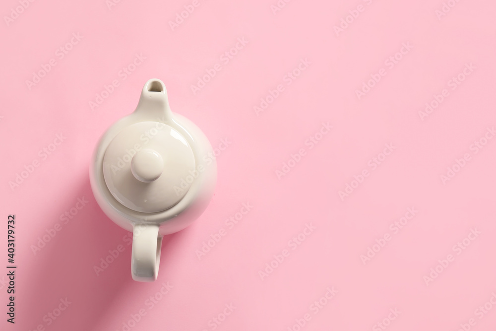 Teapot on color background, top view