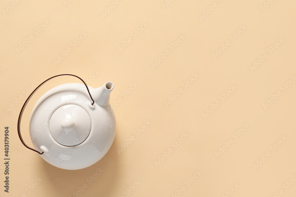 Teapot on color background, top view