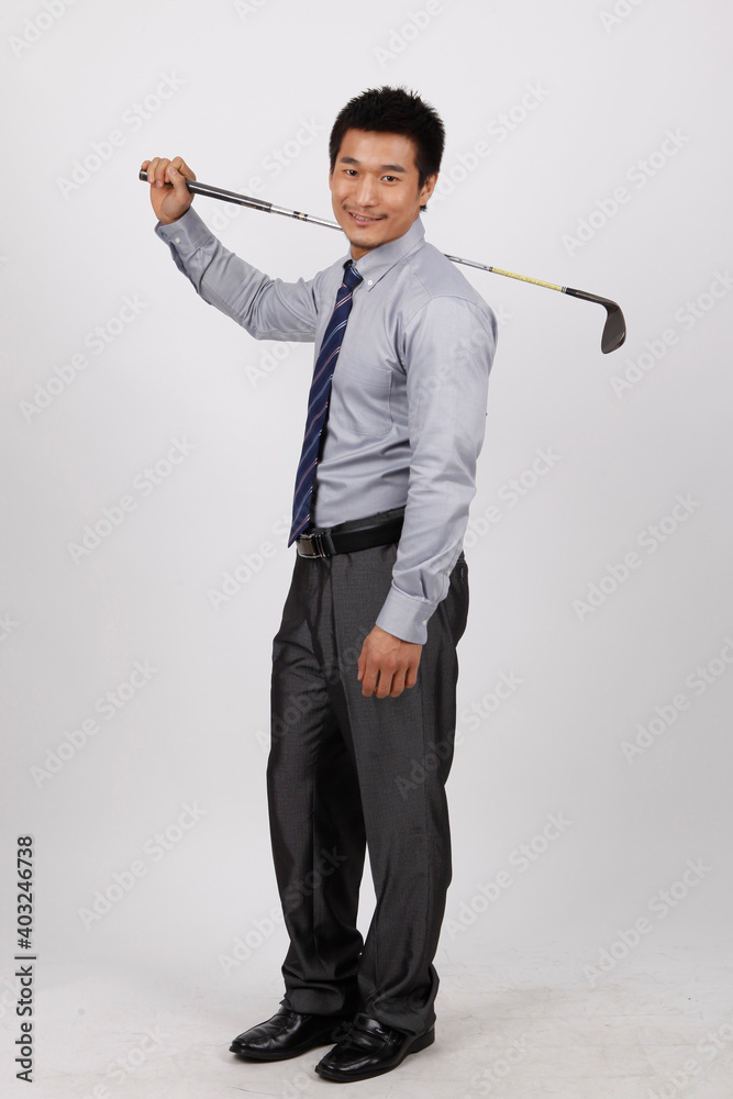 A young business man with a golf club